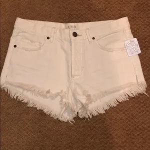 Free people white distressed denim shorts